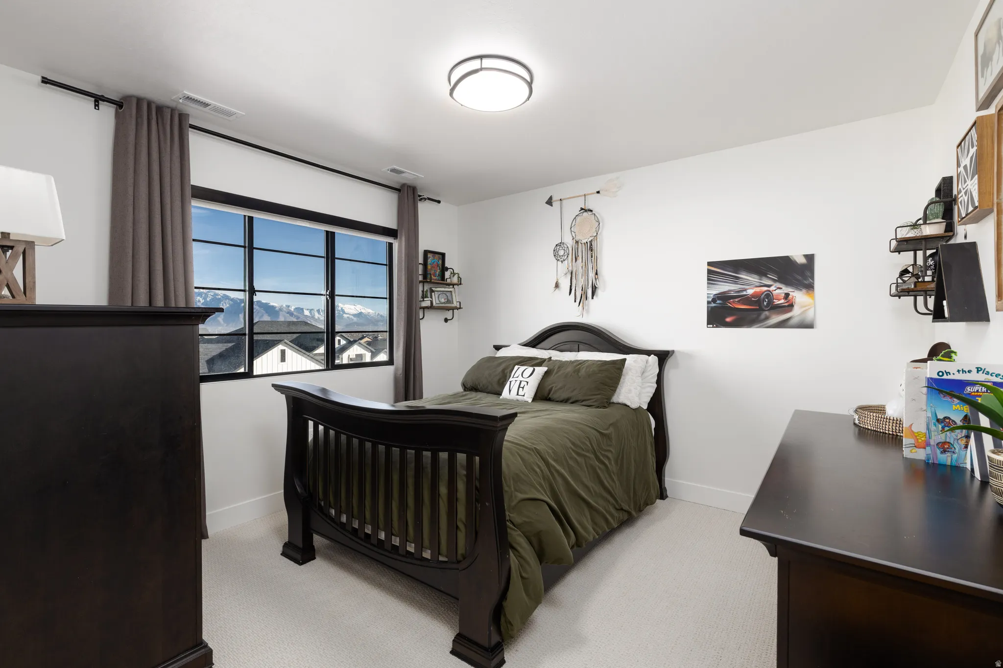 Bedroom with light colored carpet and baseboards