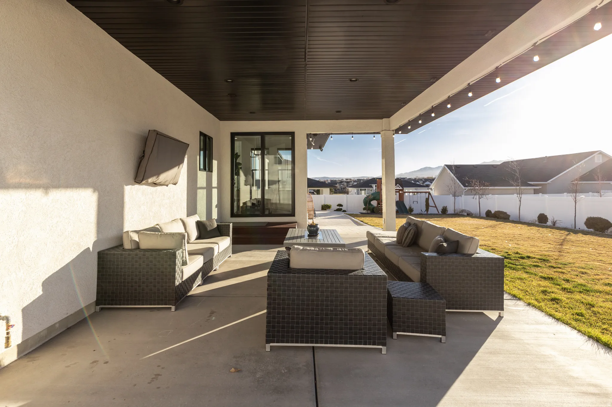 Fenced backyard with outdoor lounge area and a patio