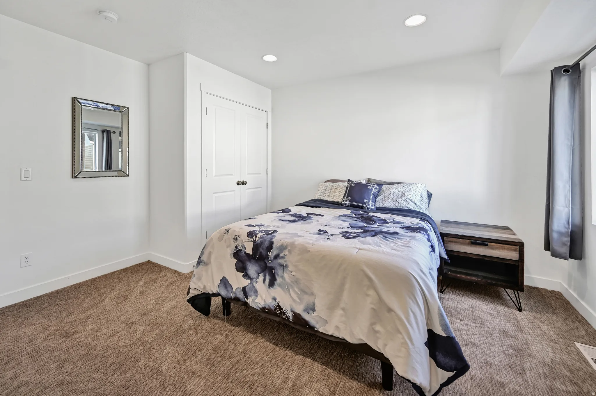 Bedroom featuring recessed lighting, carpet flooring, and a closet