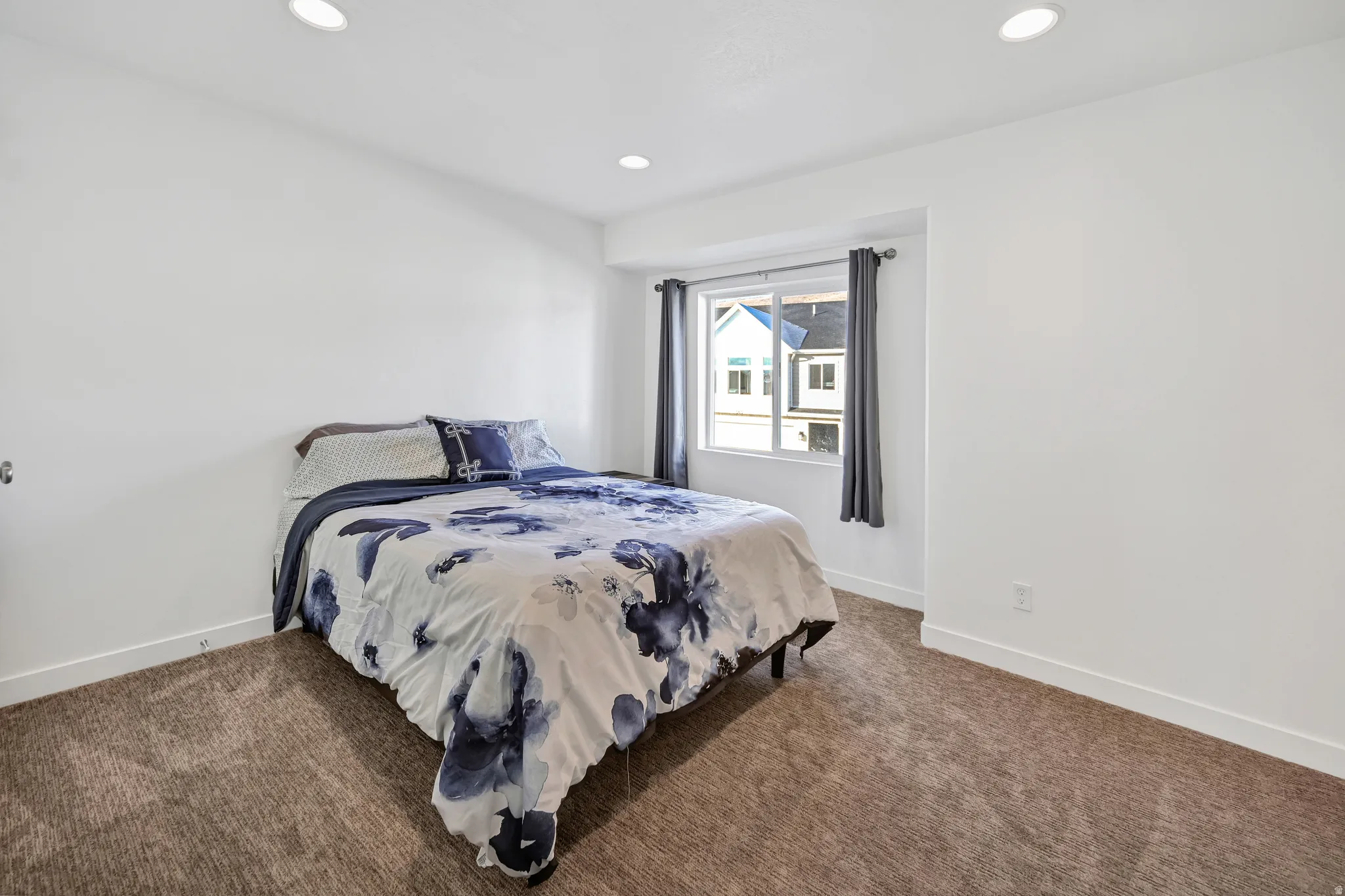 Bedroom featuring recessed lighting and dark colored carpet