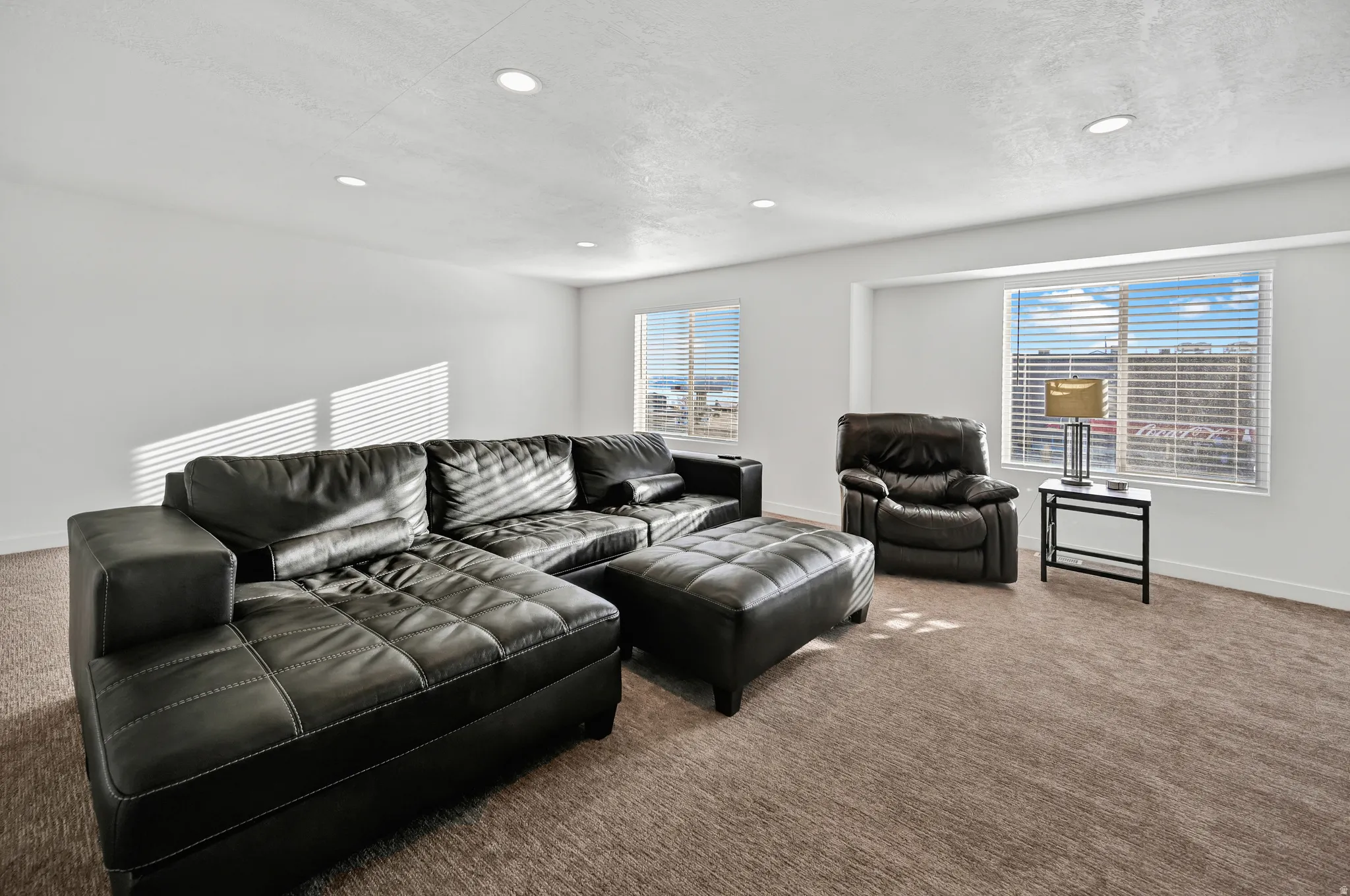 Living area featuring carpet flooring, healthy amount of natural light, and recessed lighting