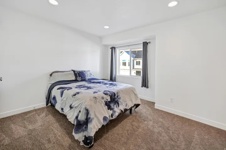 Bedroom featuring recessed lighting and dark colored carpet