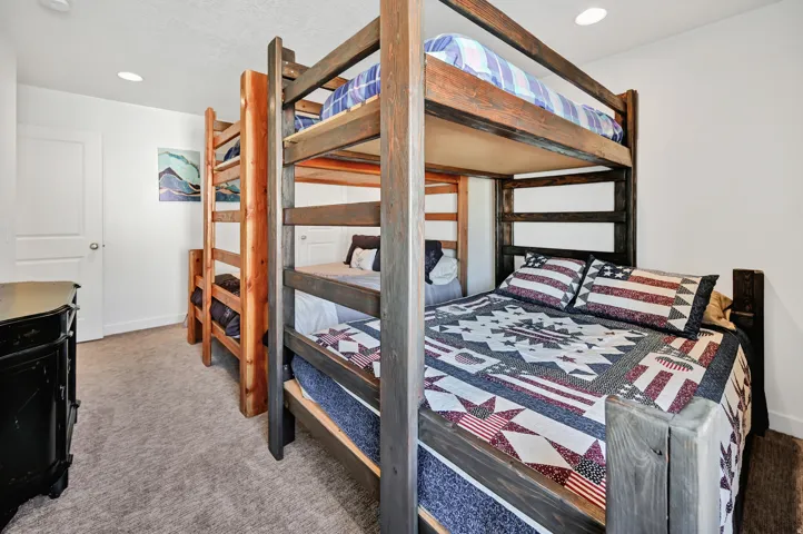 Bedroom with light carpet and recessed lighting