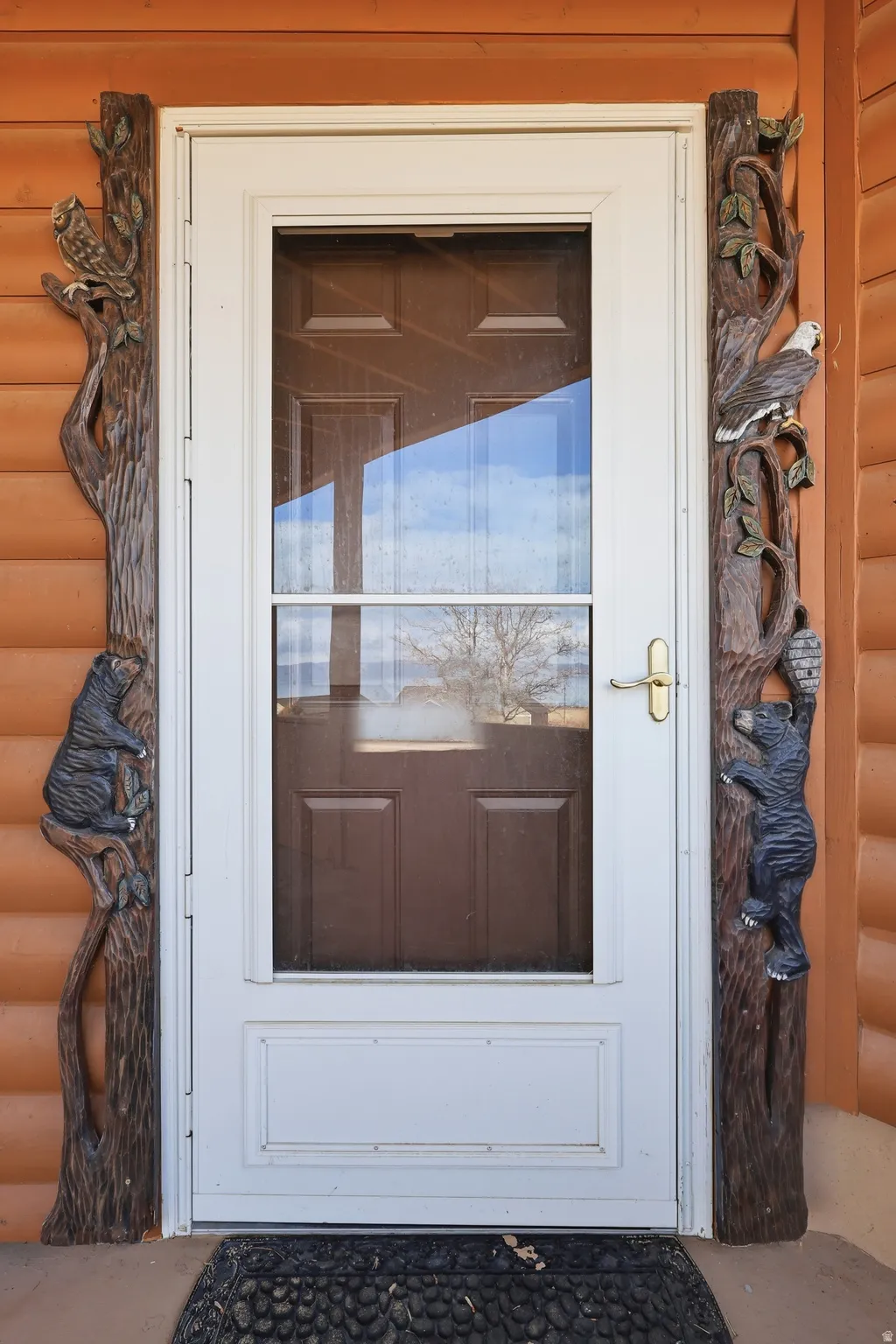 Entrance to property with faux log siding