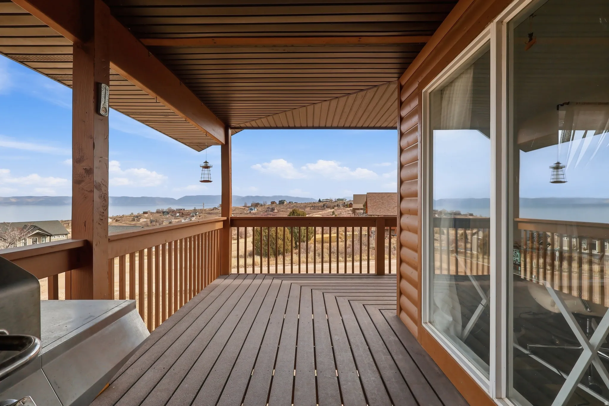 Wooden deck with a mountain view and a grill