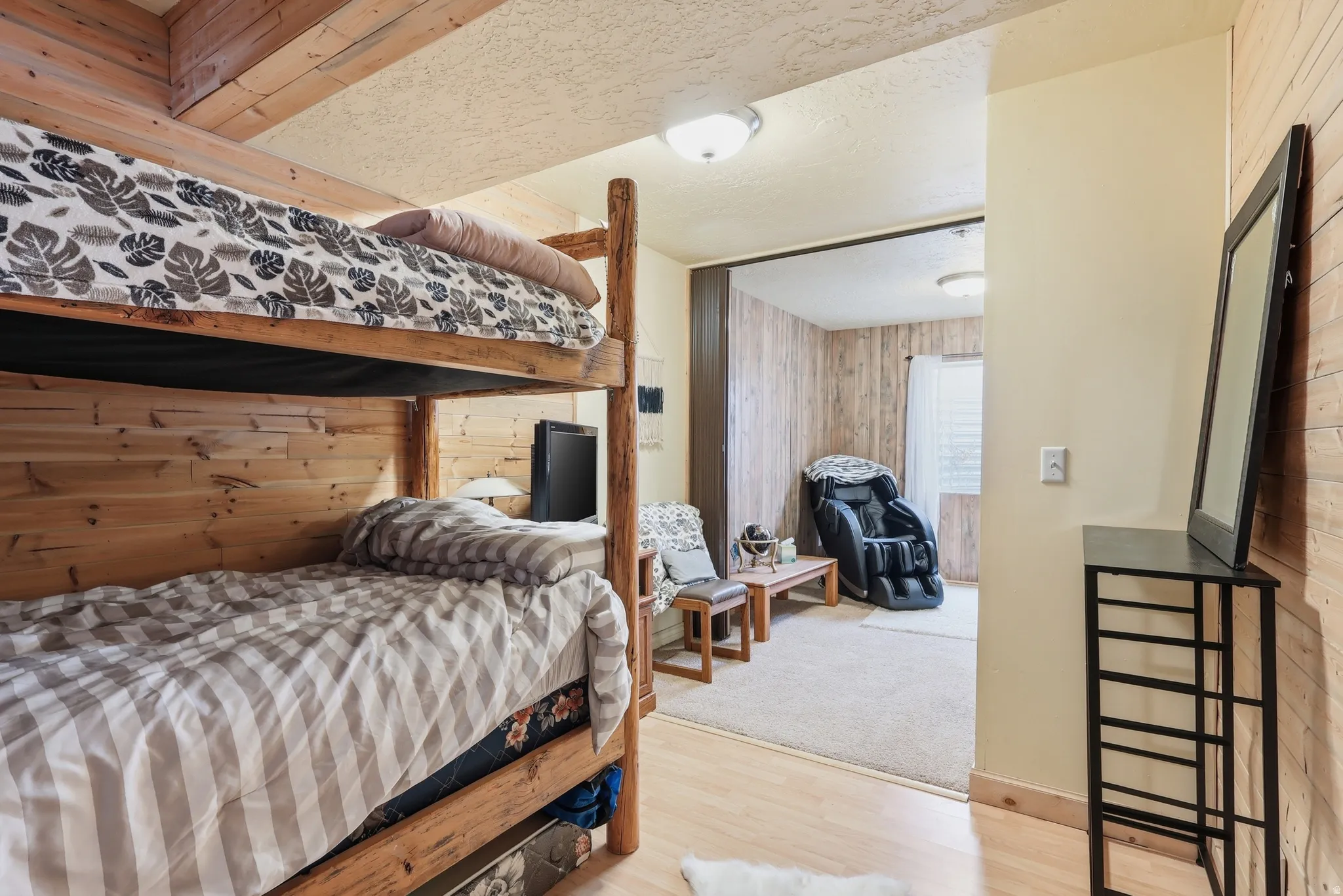 Bedroom with wooden walls and wood finished floors