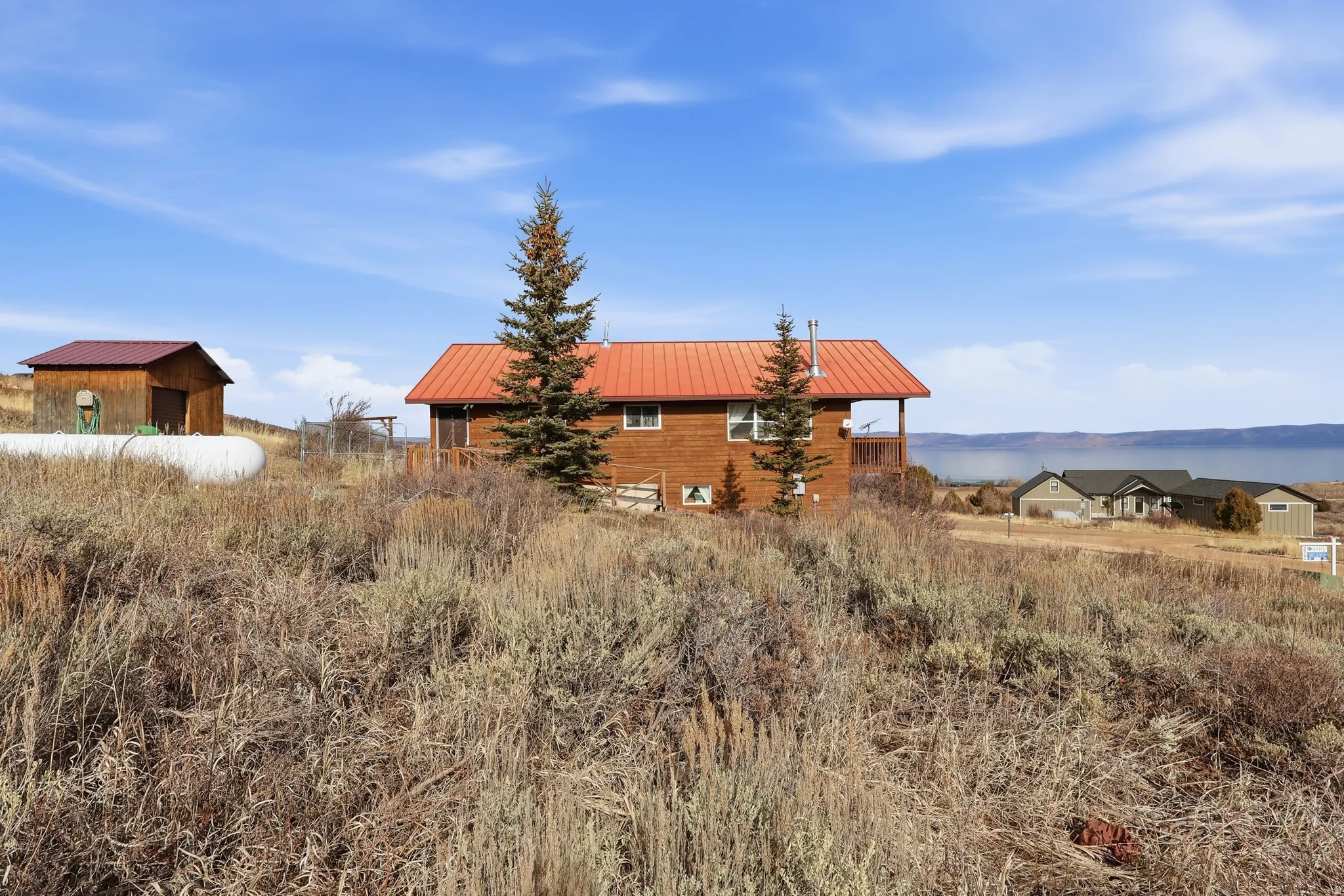 Exterior space featuring a metal roof and an outbuilding