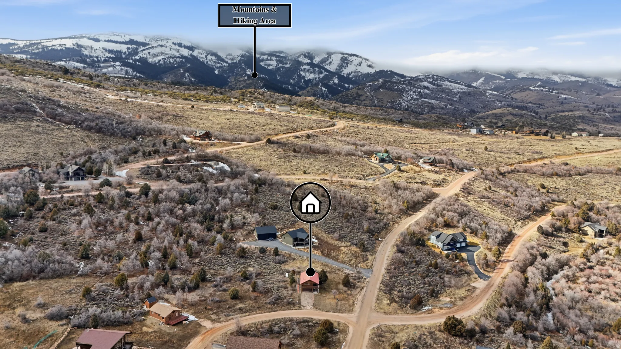 Aerial view of property and surrounding area with a mountain backdrop and rural landscape