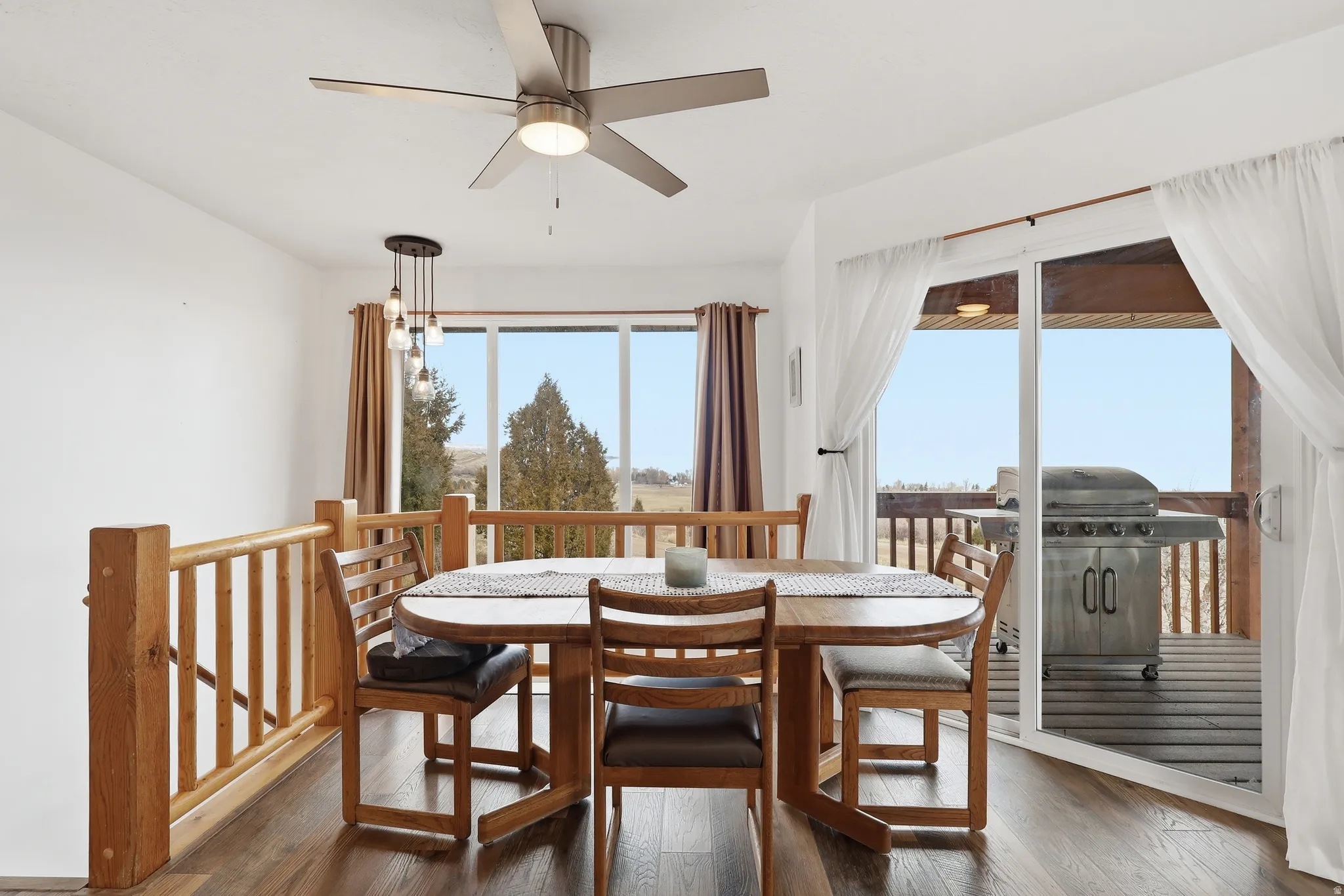 Dining room with hardwood / wood-style floors and ceiling fan