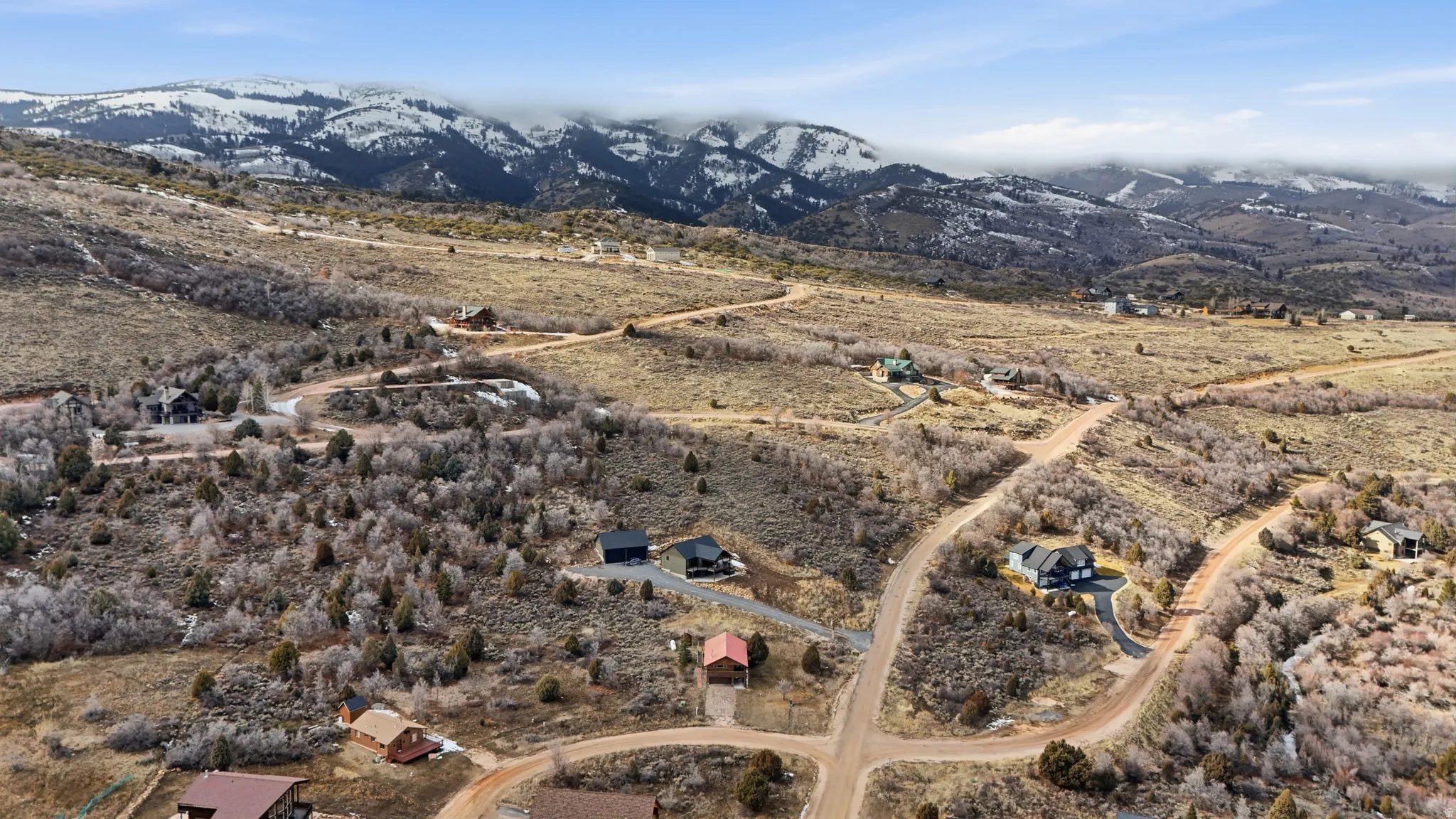 Aerial overview of property's location with mountains and rural landscape