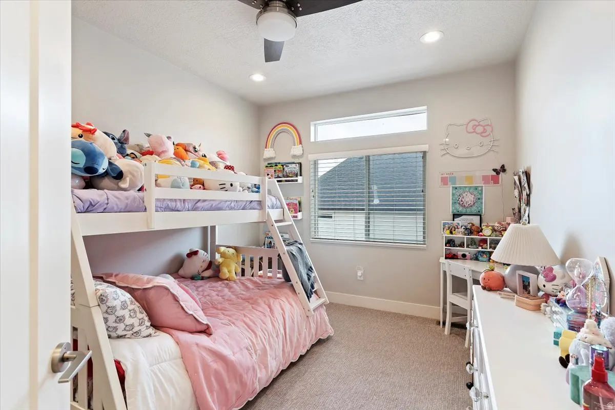 Bedroom featuring light carpet, a textured ceiling, recessed lighting, and ceiling fan