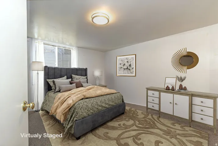 Bedroom featuring light colored carpet