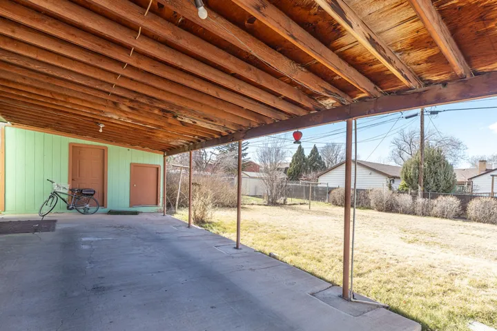 Fenced backyard with a patio