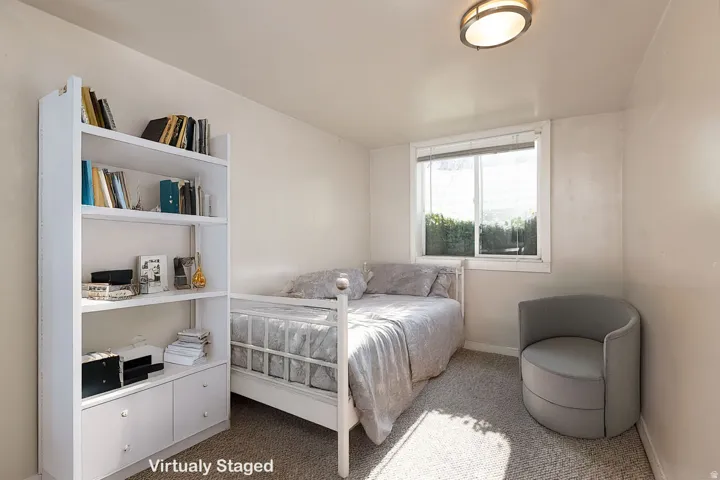 Carpeted bedroom featuring baseboards