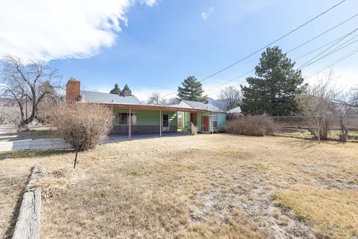 Rear view of property featuring a patio and a chimney