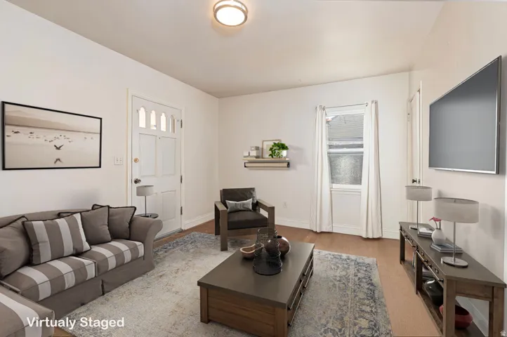 Living room with light wood-style flooring and baseboards