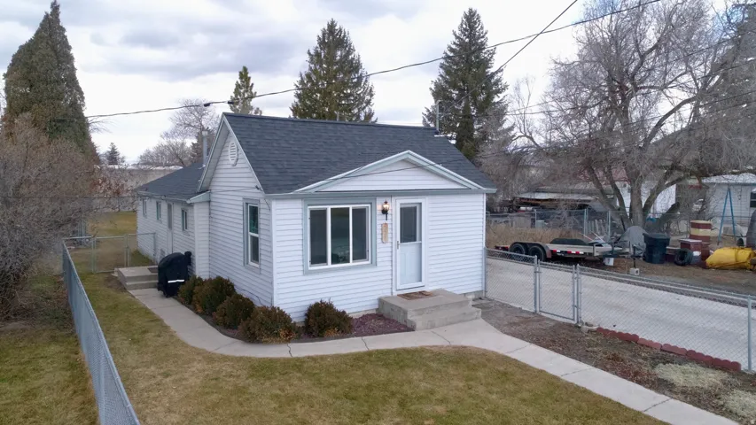 Bungalow-style house with a gate and roof with shingles