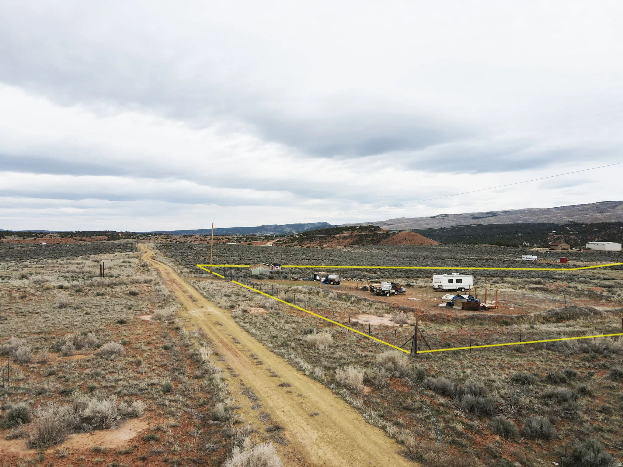 Overview of rural landscape with property boundaries highlighted and a mountainous background