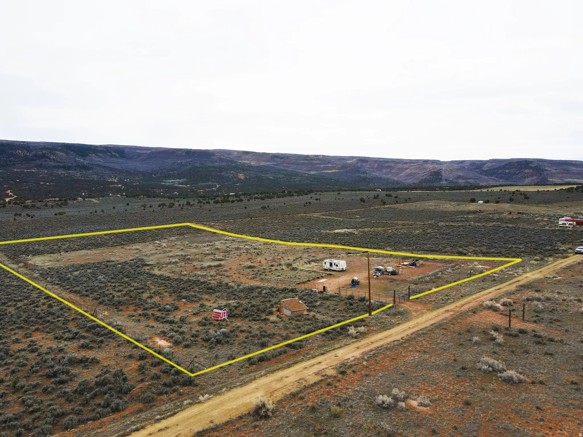 Overview of rural landscape featuring property parcel outlined and a mountainous background