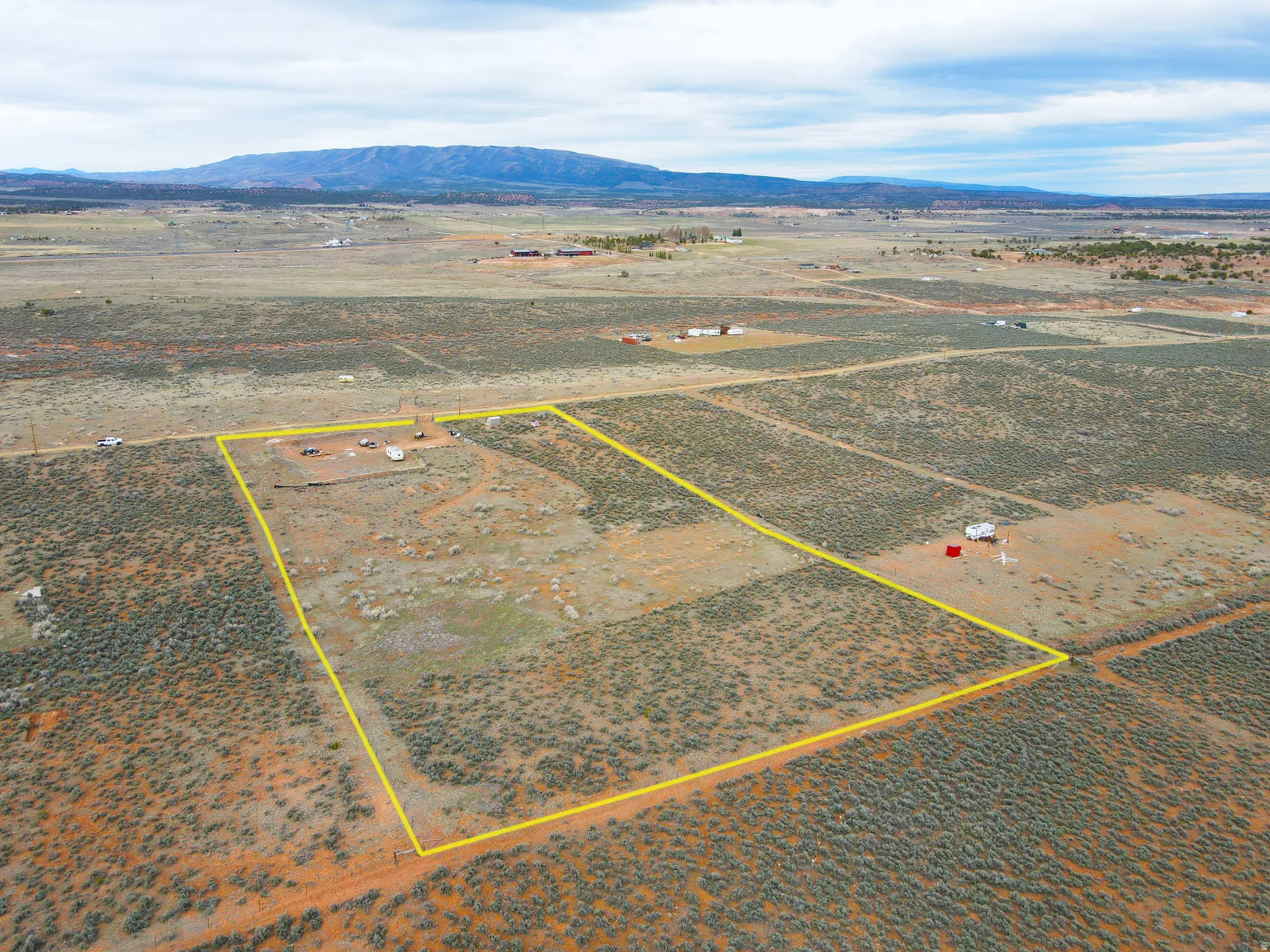 View of rural area featuring a mountain backdrop and property parcel outlined
