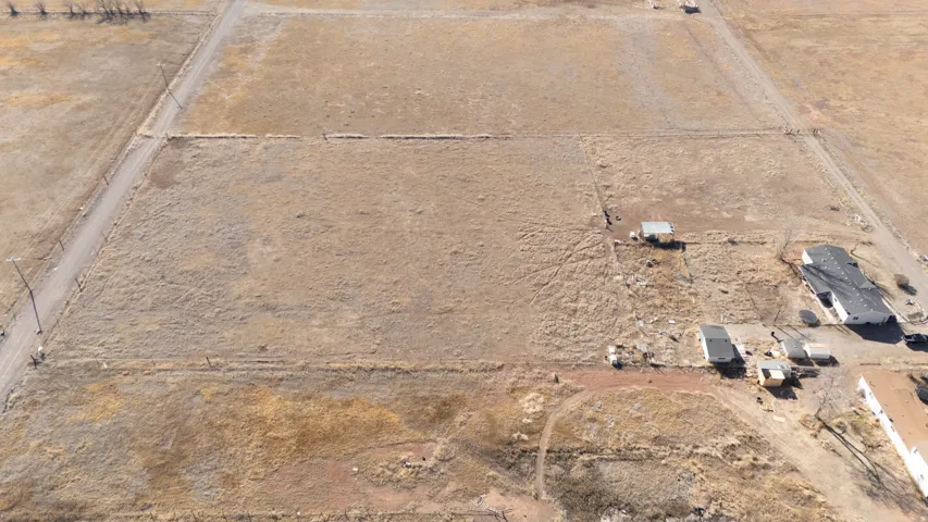 Aerial view of property and surrounding area featuring rural landscape and a desert landscape