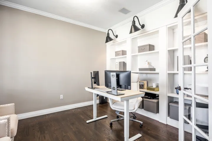 Home office featuring crown molding and dark wood finished floors
