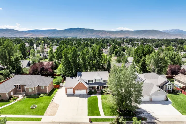 Aerial perspective of suburban area with a mountainous background