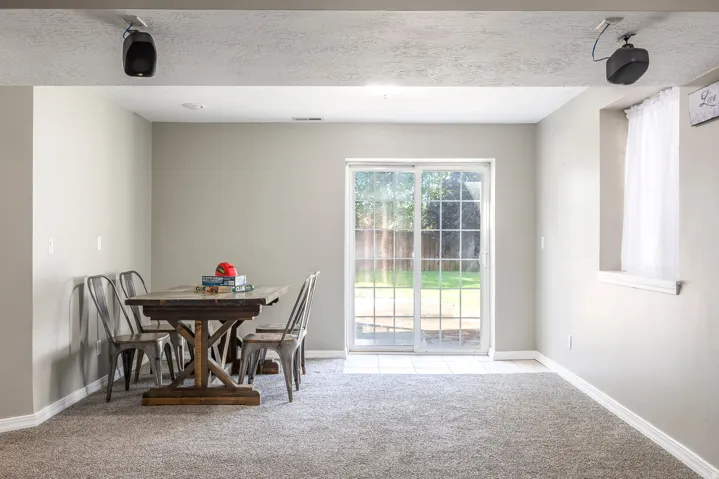 Dining room with light carpet and a textured ceiling