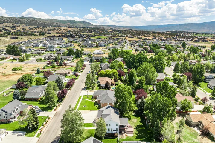 Aerial view of residential area featuring a mountainous background