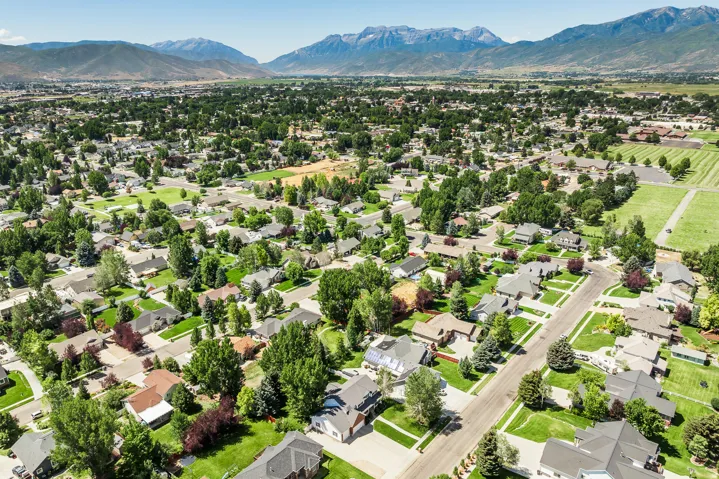 Aerial perspective of suburban area with a mountainous background