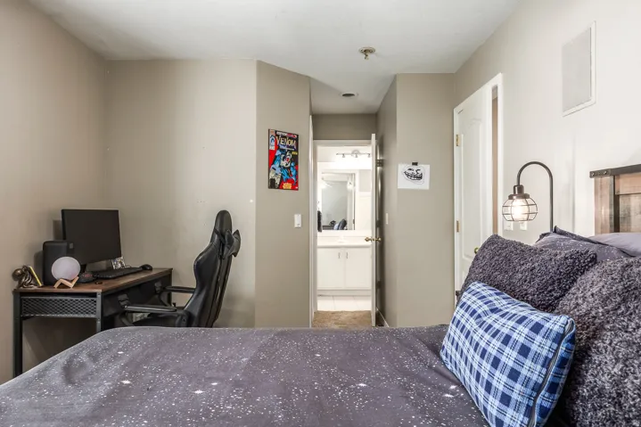 Bedroom with an office area and connected bathroom