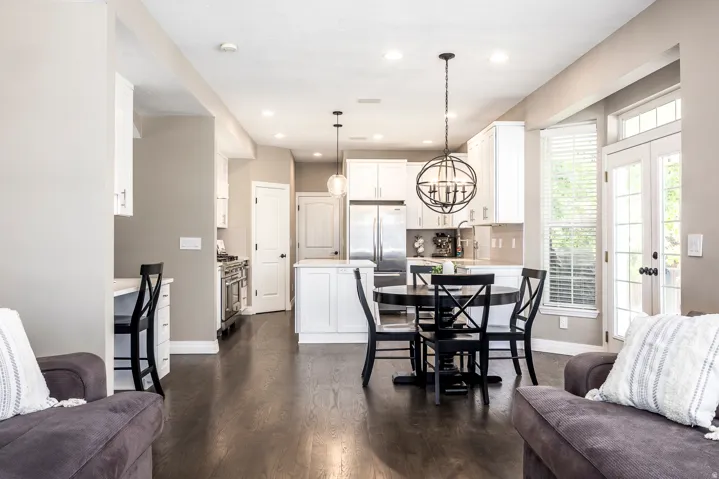 Dining space featuring dark wood-style floors and hanging lights
