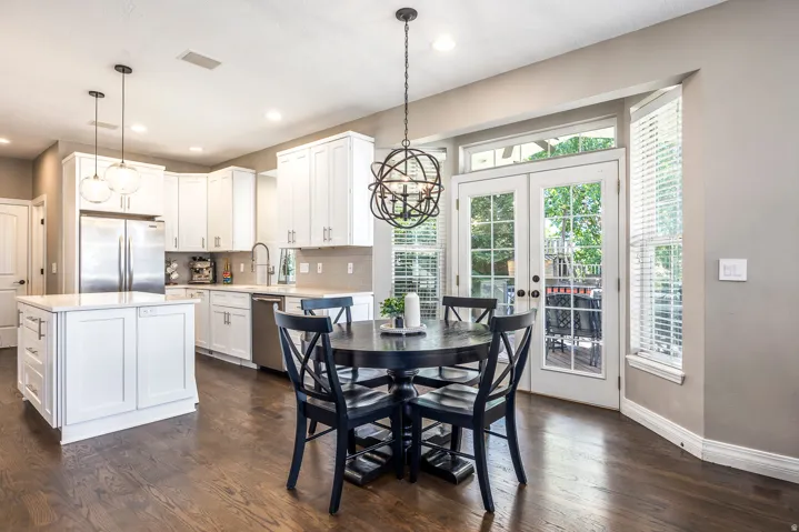 Dining room featuring a chandelier, french doors, and dark wood-style floors
