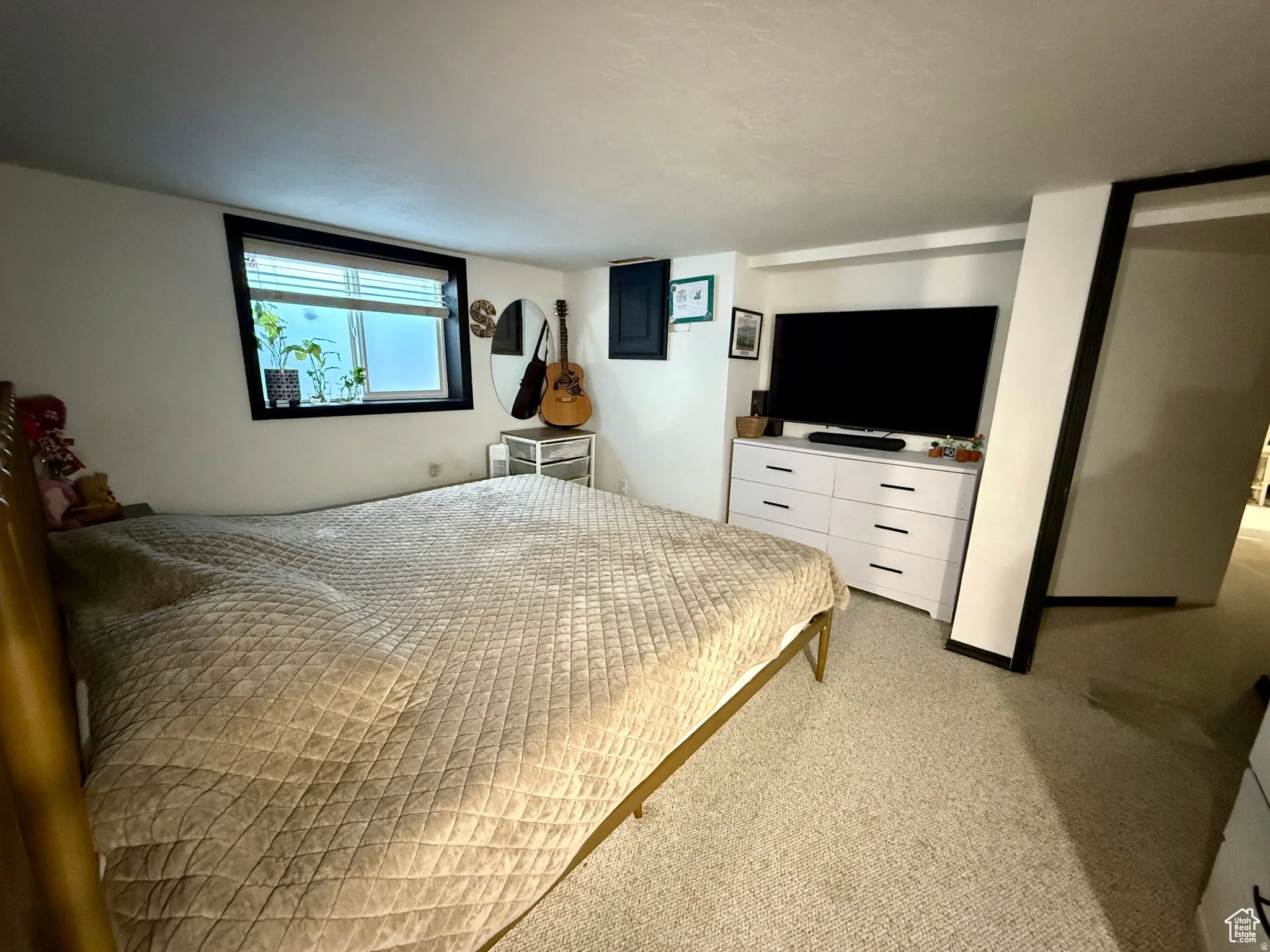 Bedroom with light colored carpet