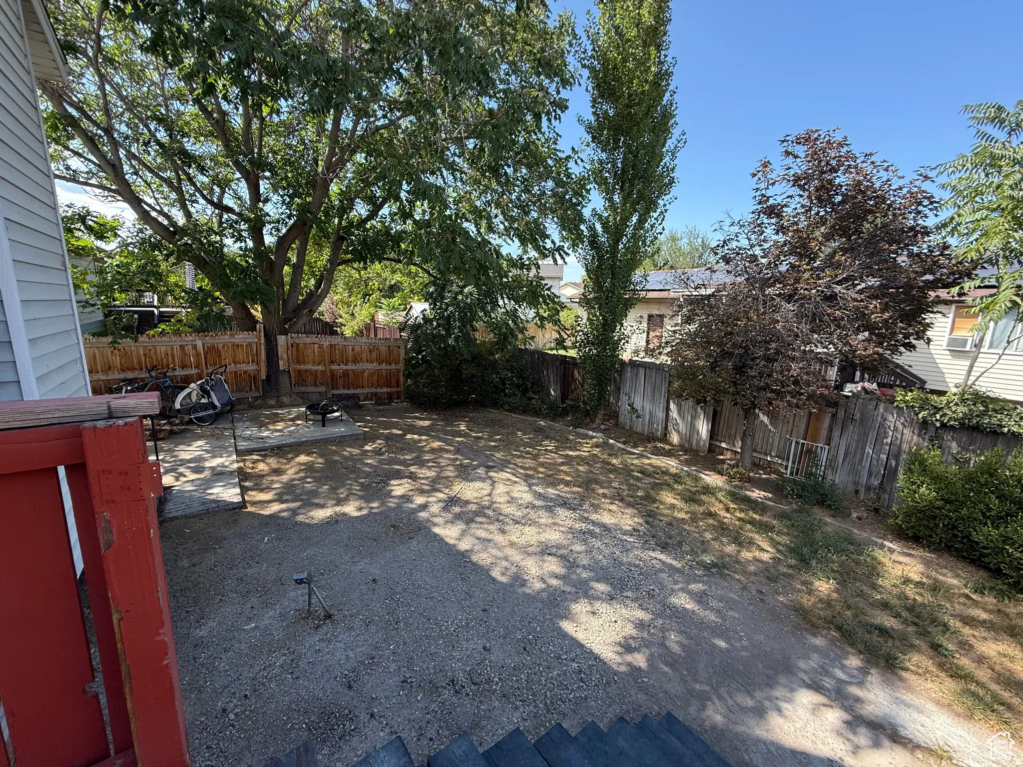Fenced backyard featuring a patio
