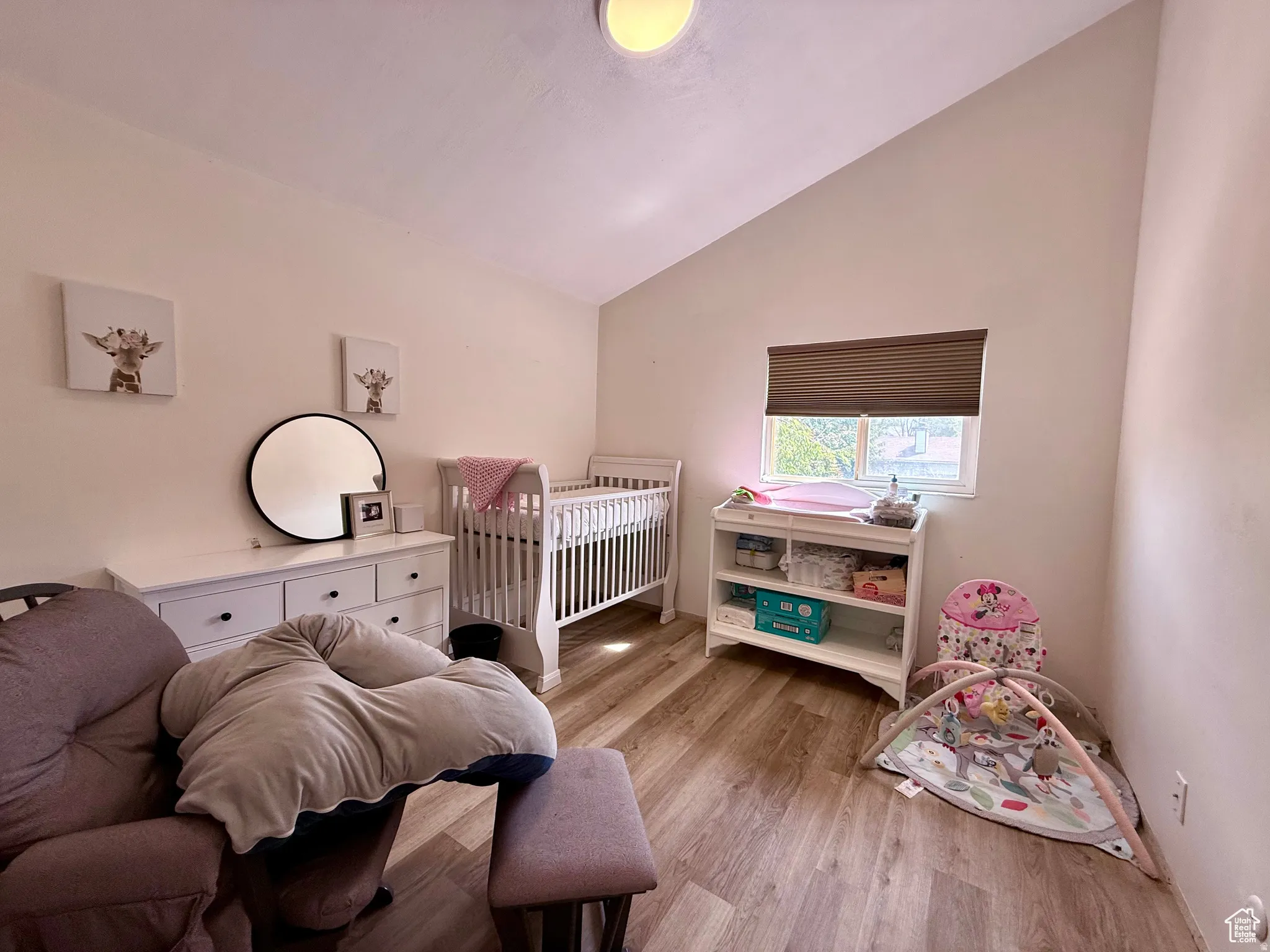 Bedroom featuring vaulted ceiling and light wood finished floors