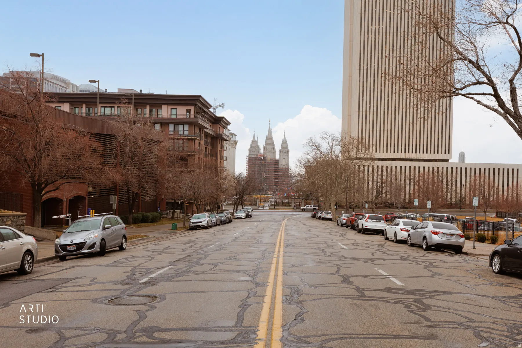 View of asphalt road with street lights and curbs