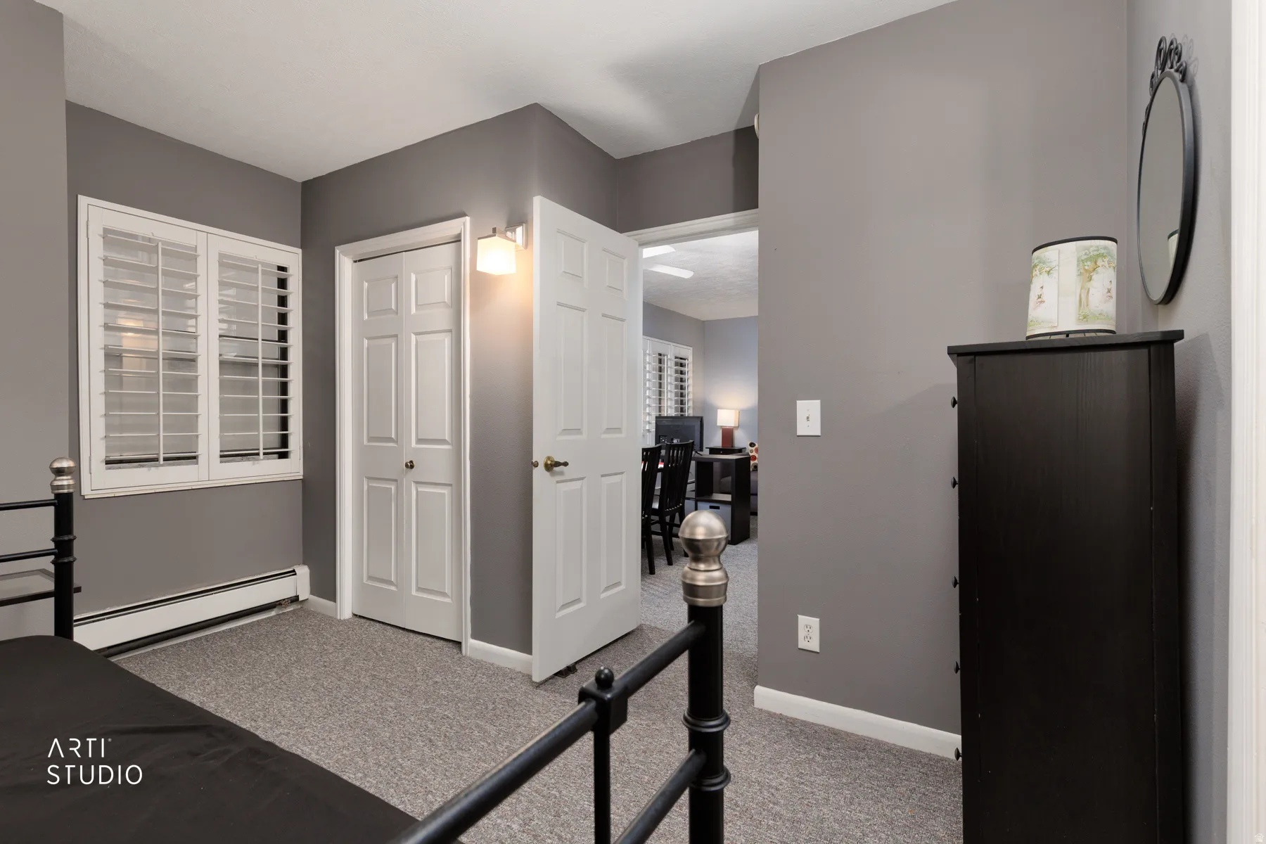 Workout room with light carpet and a baseboard radiator