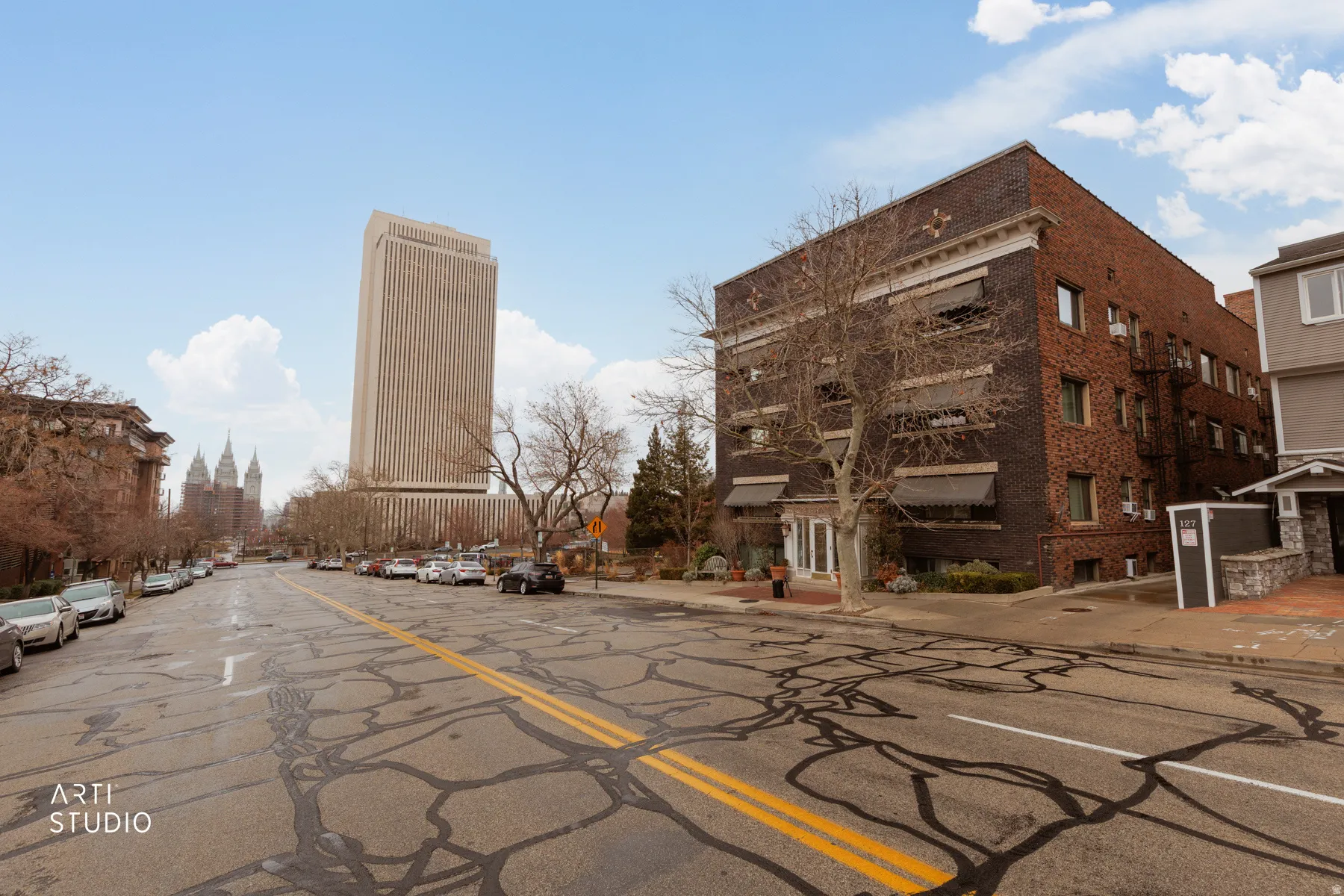 View of asphalt street with sidewalks and curbs