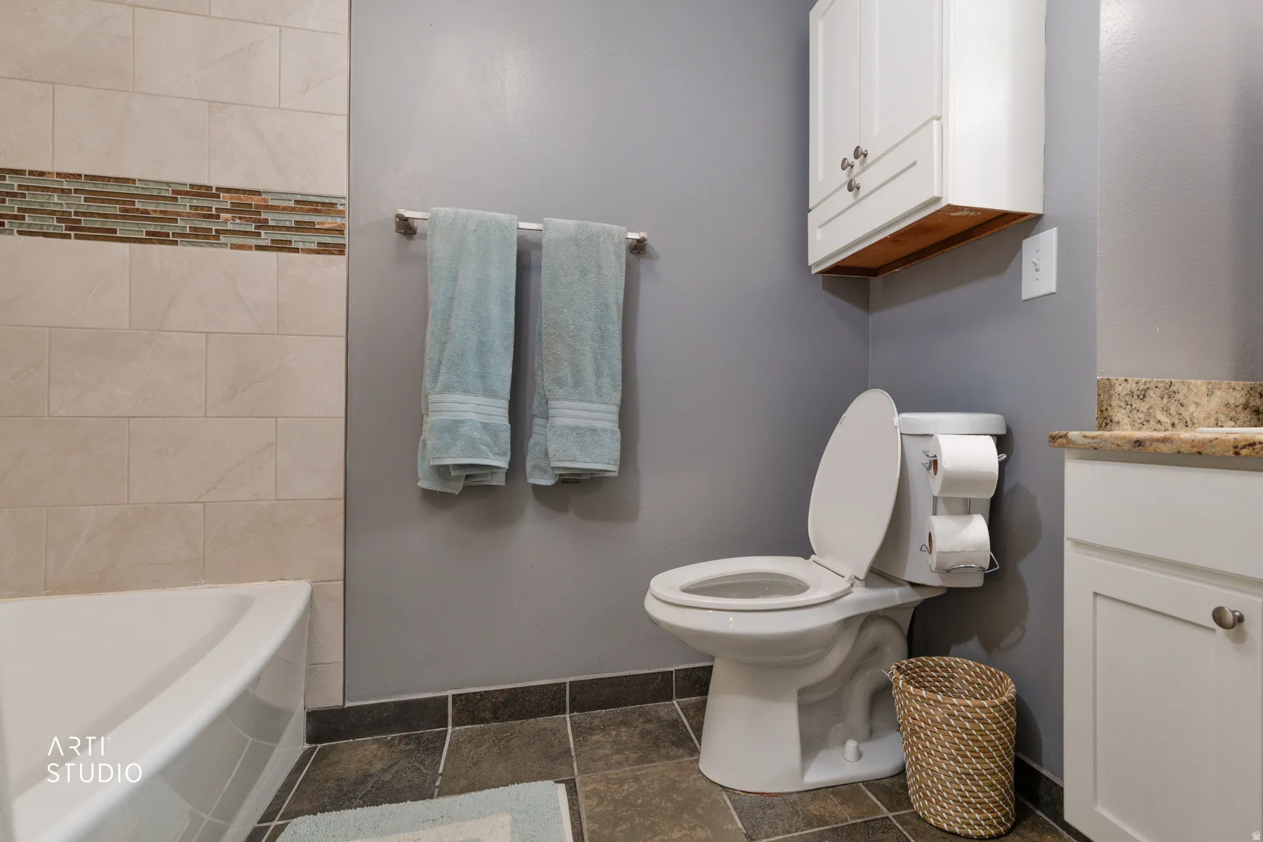 Bathroom with vanity and bathing tub / shower combination