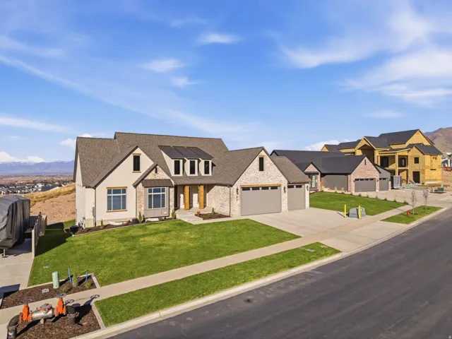 Modern inspired farmhouse with roof with shingles, driveway, a mountain view, a front lawn, and a garage
