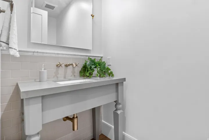 Bathroom with vanity and tile walls