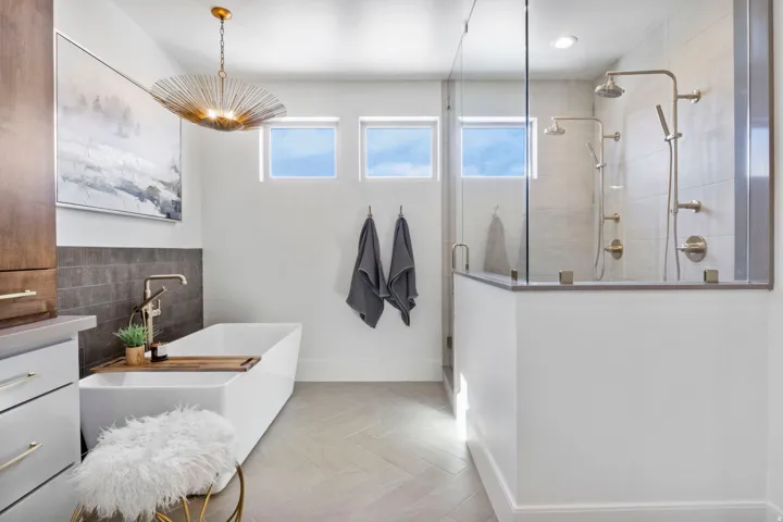 Full bath featuring a shower stall, a freestanding bath, healthy amount of natural light, and vanity