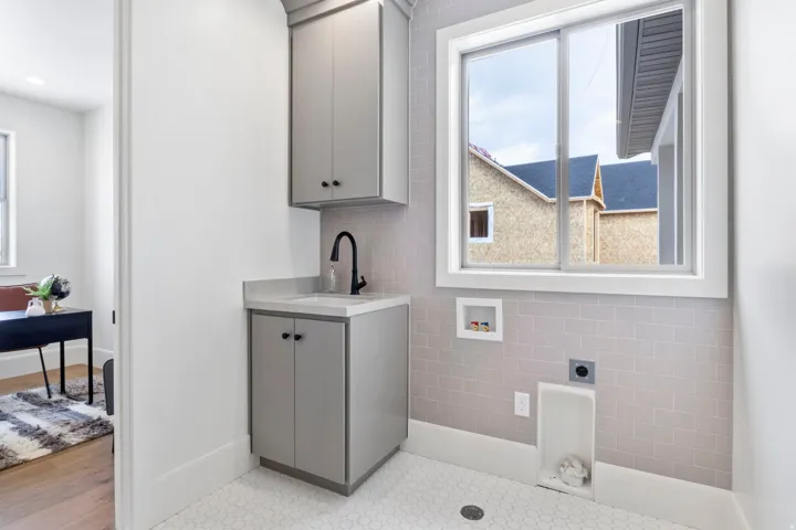Laundry room with hookup for a washing machine, electric dryer hookup, and cabinet space