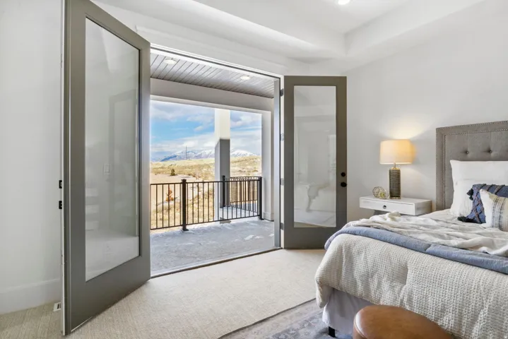 Carpeted bedroom featuring access to outside and a mountain view