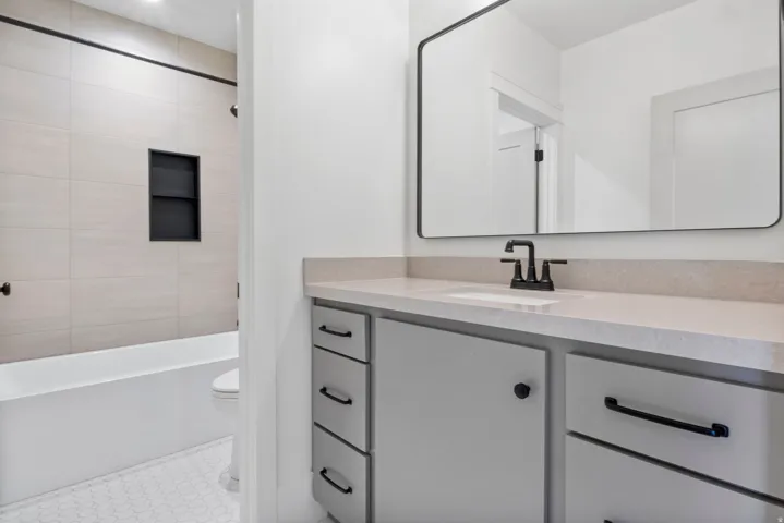 Bathroom featuring vanity and shower / bathtub combination