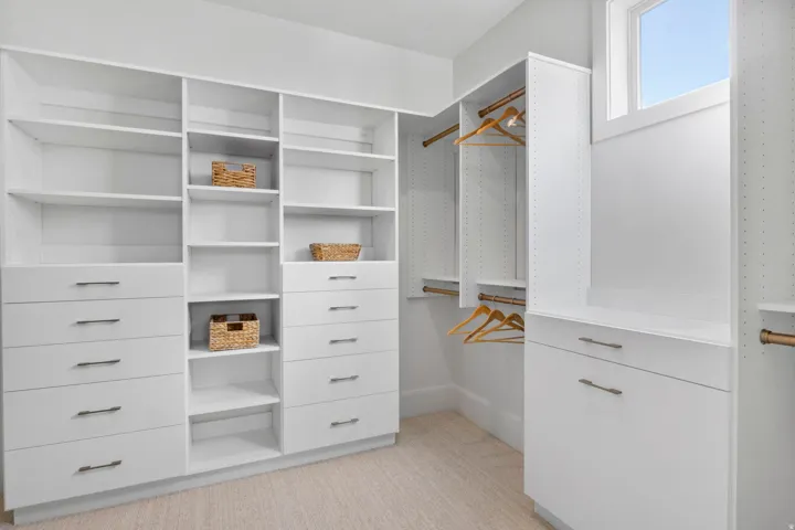 Walk in closet with light carpet