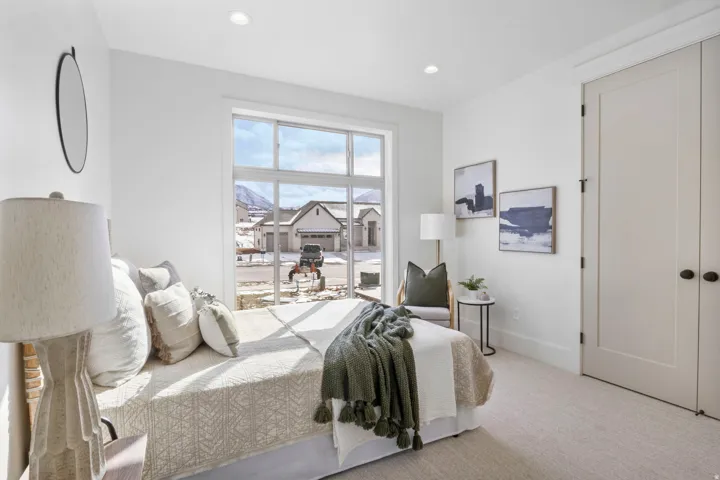 Carpeted bedroom with baseboards and recessed lighting