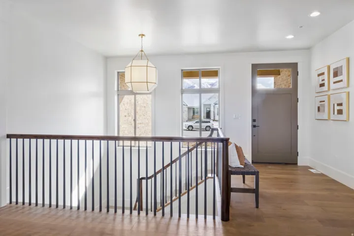 Foyer with wood finished floors and recessed lighting