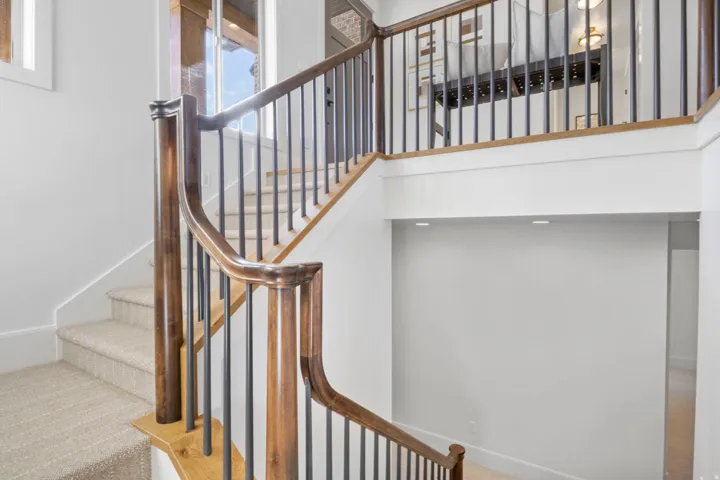 Stairs with a high ceiling and carpet floors